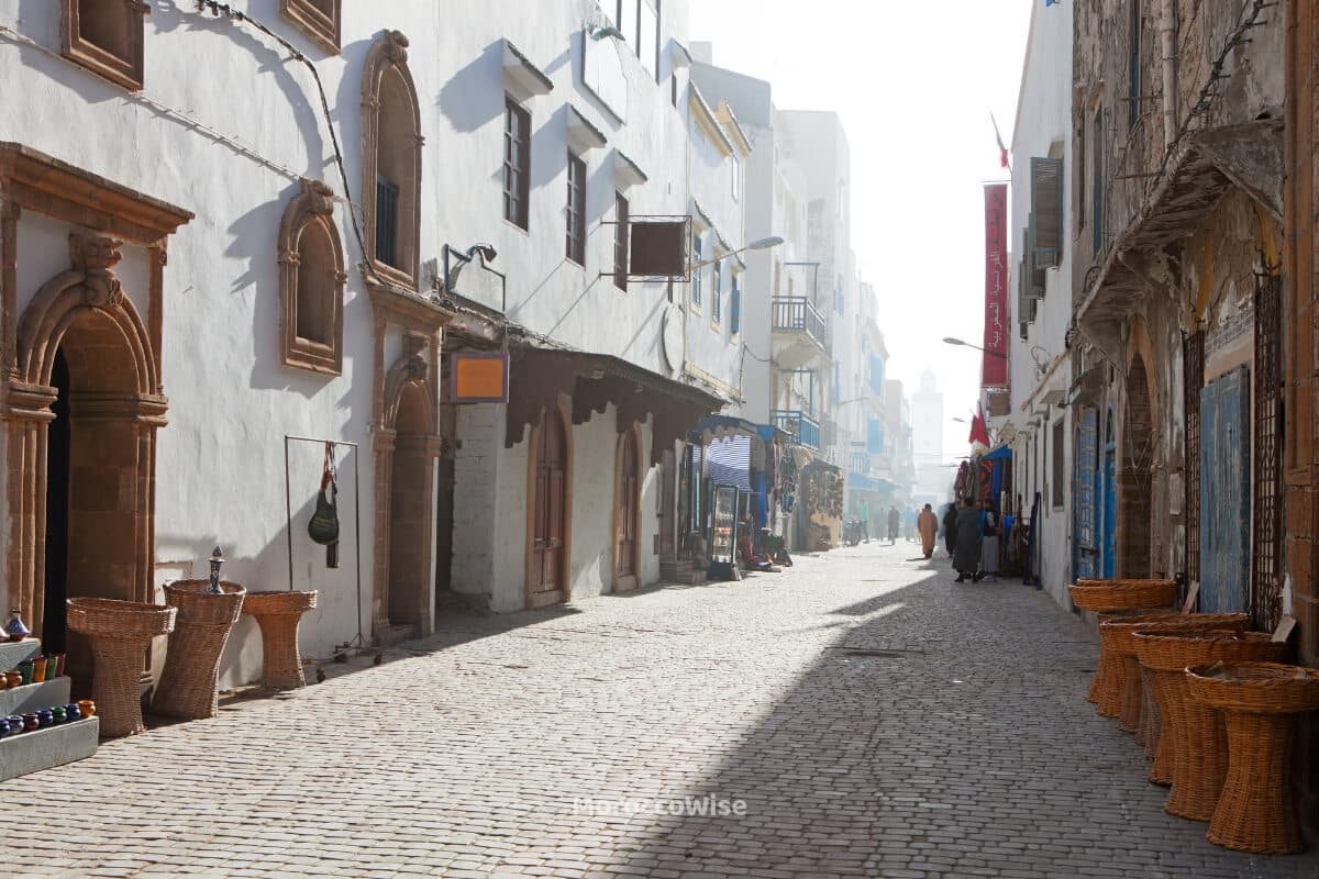 A sunlit passage winding through the historic Essaouira medina