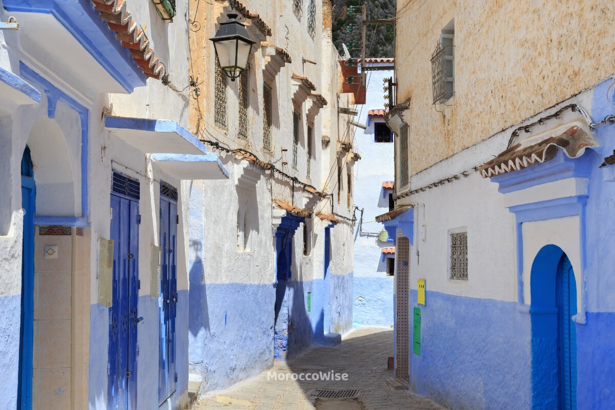 A quiet blue alley in Chefchaouen photographed in soft morning light